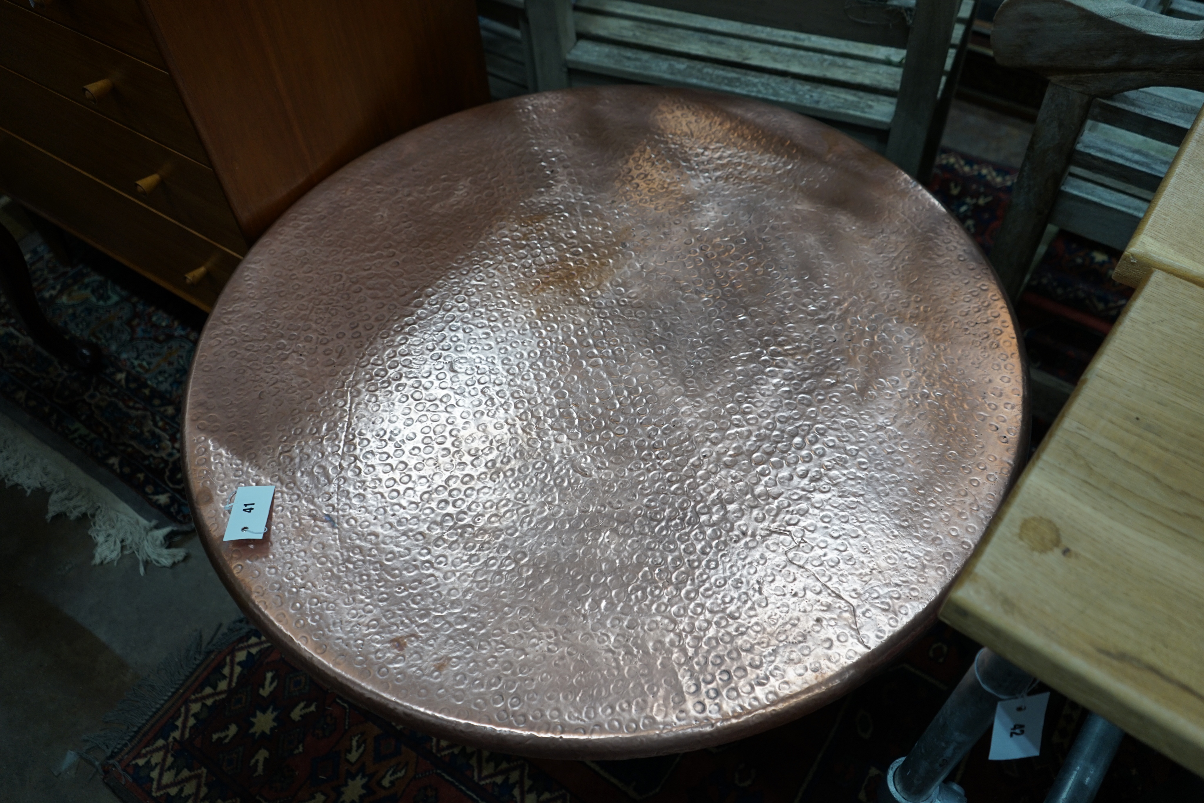 A circular hammered copper and wrought iron low table, diameter 88cm height 49cm